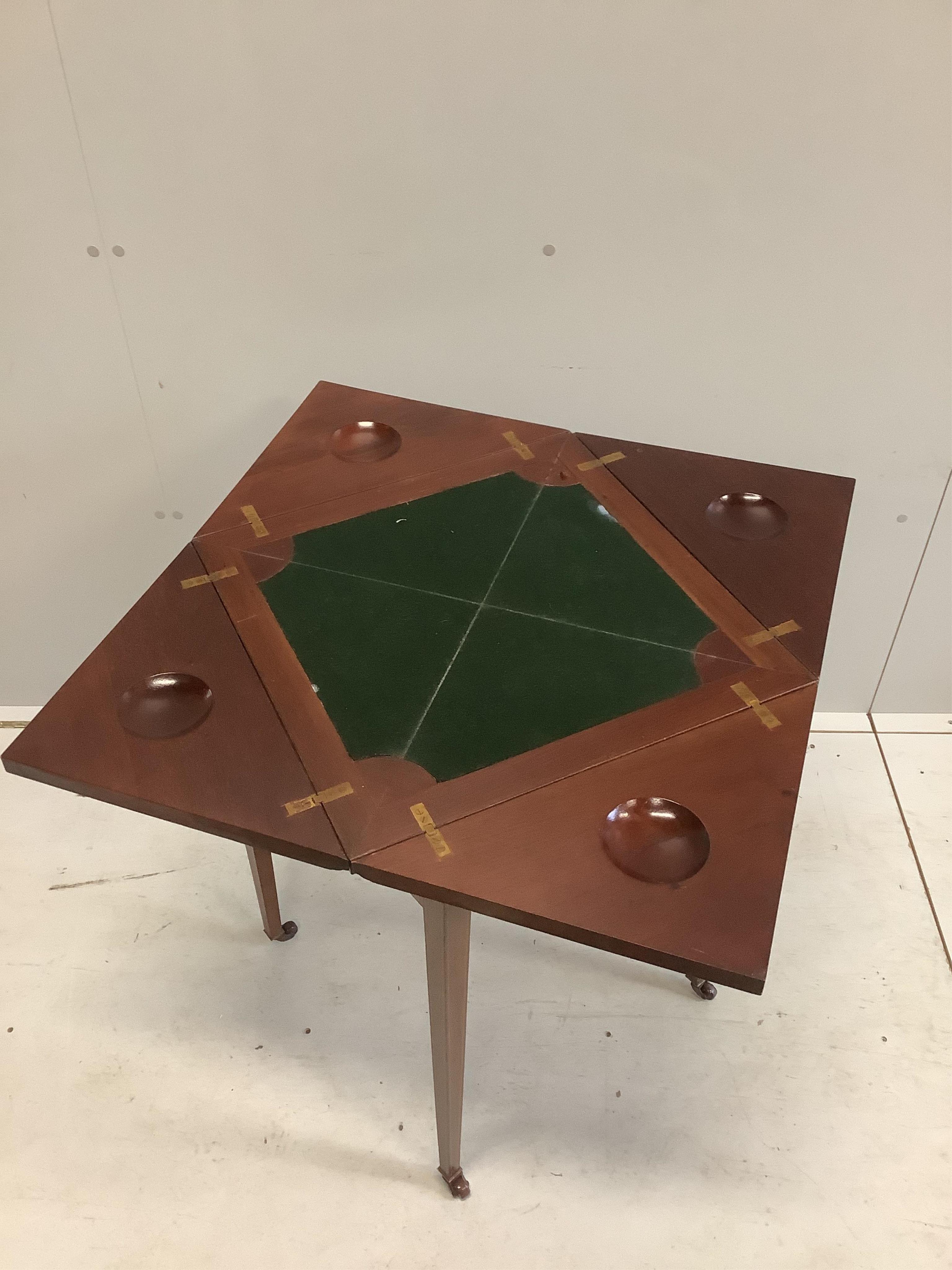 An Edwardian inlaid mahogany envelope card table, width 51cm, depth 51cm, height 75cm. Condition - good